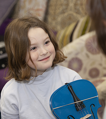 child smiling in music lesson