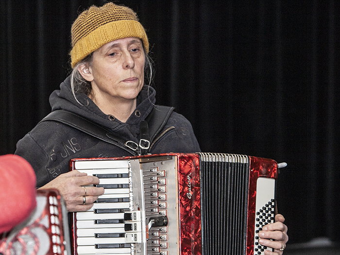 Adult playing in accordion workshop