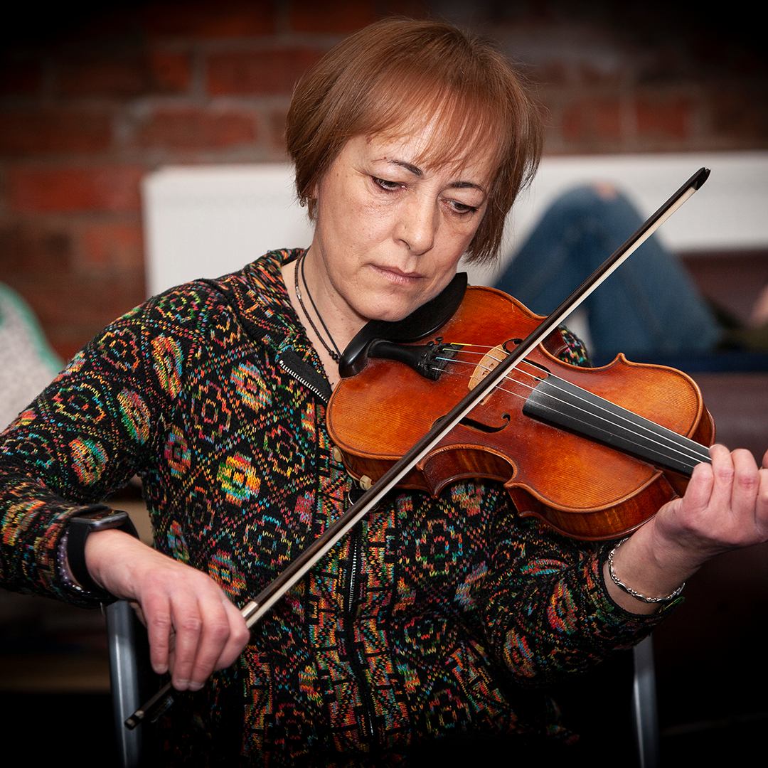 Adult playing fiddle