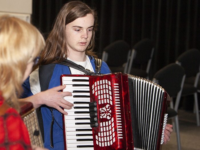 Young man in accordion workshop
