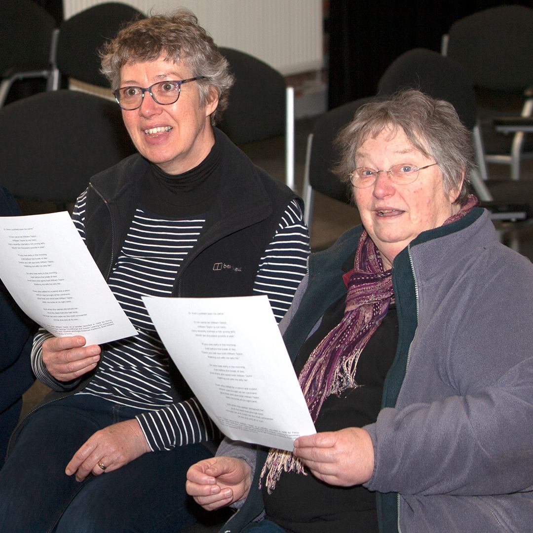 Two adult ladies singing in folk song workshop